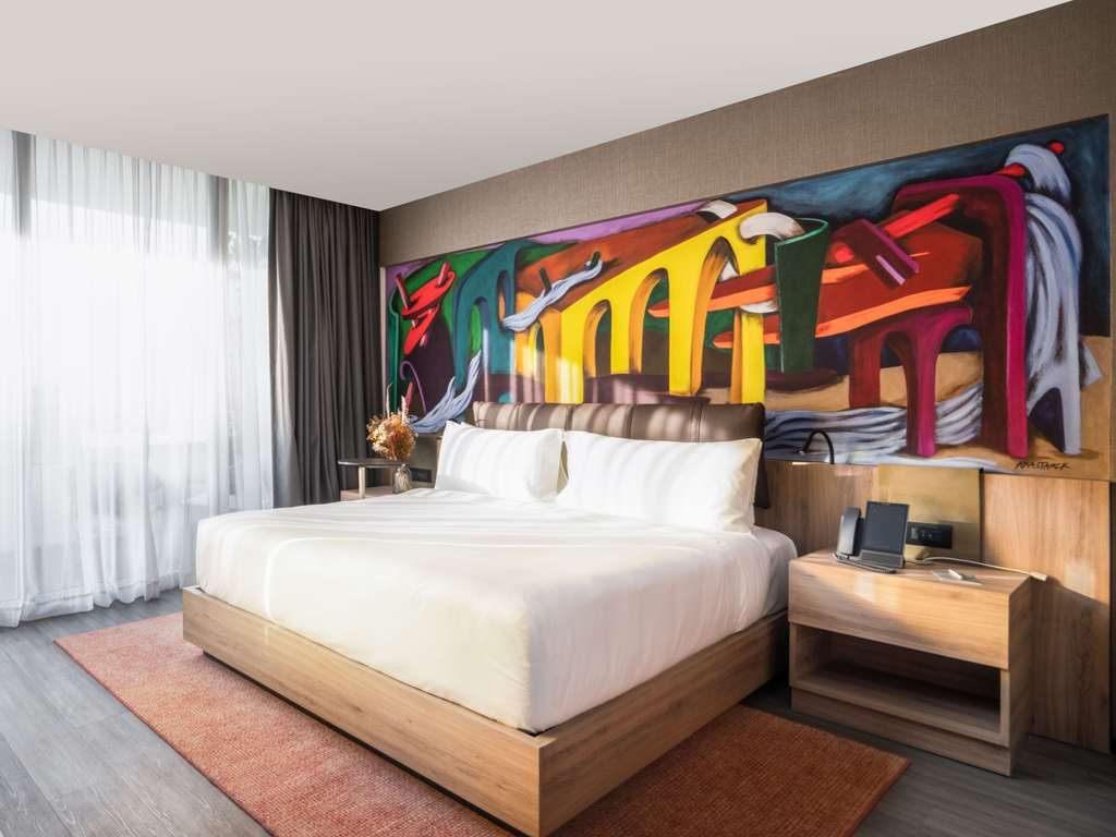 A hotel room in Mexico City with a painted mural
