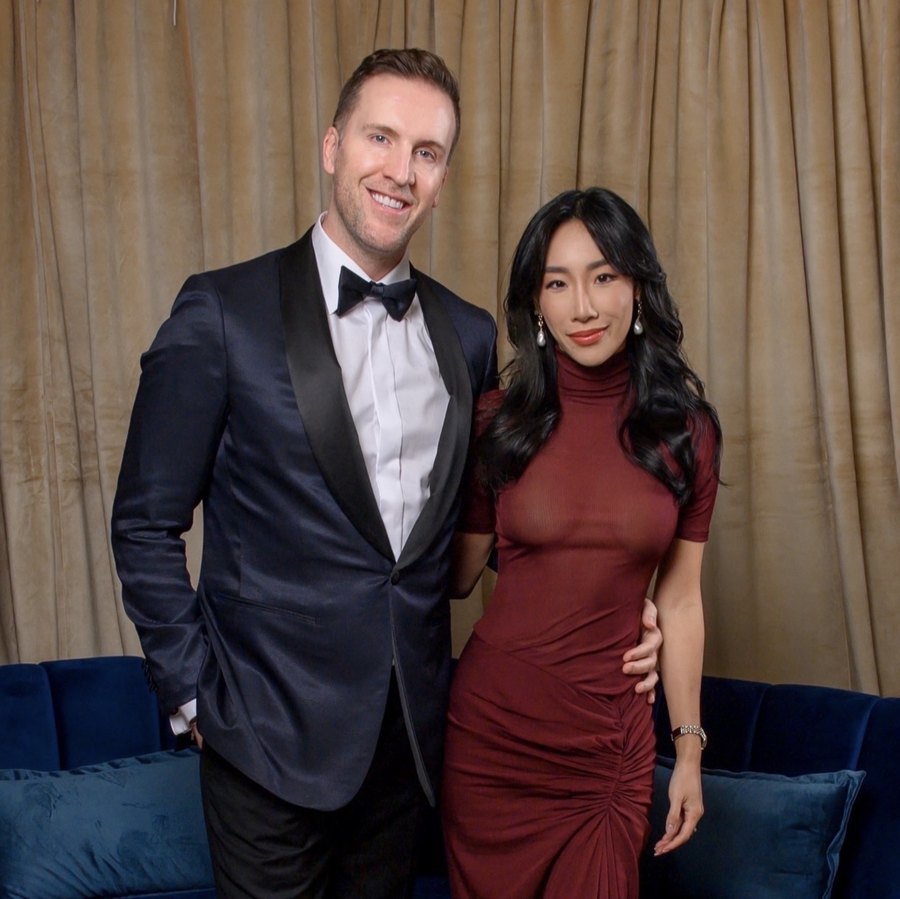 Eva and her partner dressed for a black-tie evening